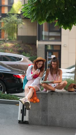 two women relaxing on the street