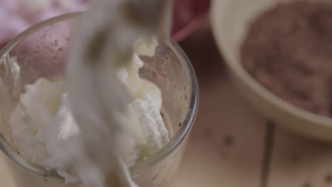 fresh whipped cream over hot chocolate with marshmallow and chocolate ingredients