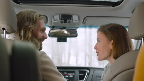 happy friends sitting in a car talking and laughing together 1