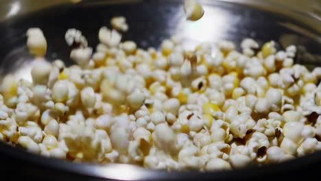 close-up of popcorn being poured into a bowl