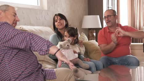 playful non- normative family sitting on the sofa