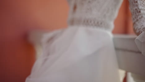 woman in old fashioned wedding dress at balcony railing