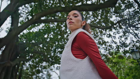 fit woman standing park in fitness attire before daily workout closeup. athlete