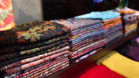 colorful fabrics neatly stacked on display shelves