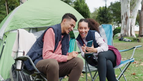 Couple,-reading-and-cellphone-at-camp