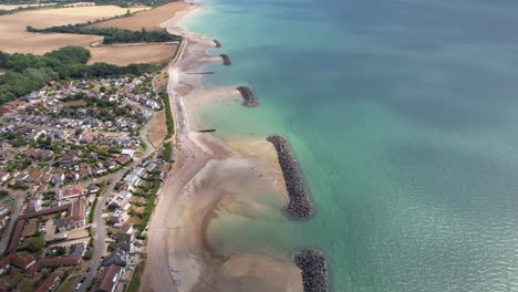 elmer sands beach with turquoise water in west sussex, uk - aerial drone shot