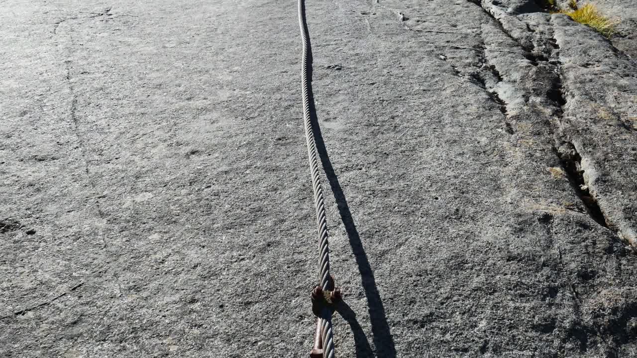 massive rock slabs with steel cable and hiker