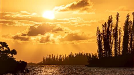 Golden-hour-sunset-timelapse-of-islands,-moving-water-around-Isle-of-Pines