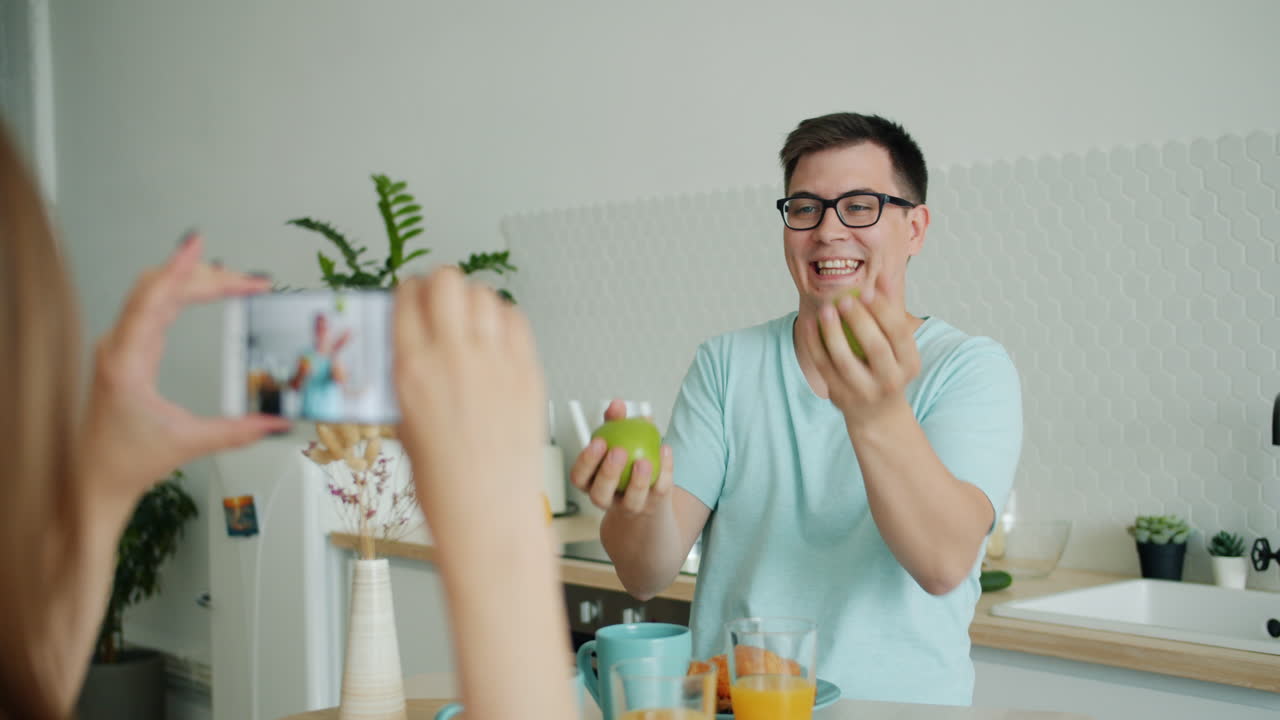 Couple Taking Funny Photos While Eating Breakfast