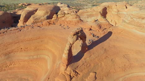 aerial view of people hiking towards the sandstone rock formations in arches national park, utah, usa