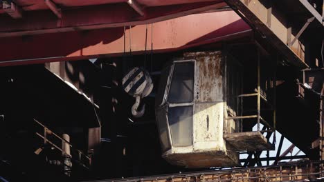 old, rusted crane in an abandoned industrial setting