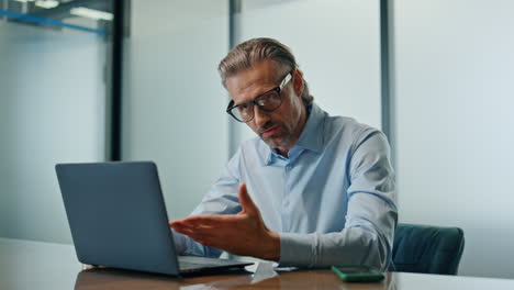 Serious-director-talking-computer-office-close-up.-Angry-man-arguing-video-call