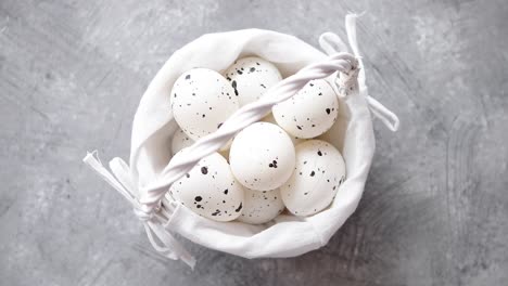 Composition-of-white-traditional-dotted-Easter-eggs-in-white-wicker-basket