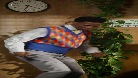 people dancing in a room with plants