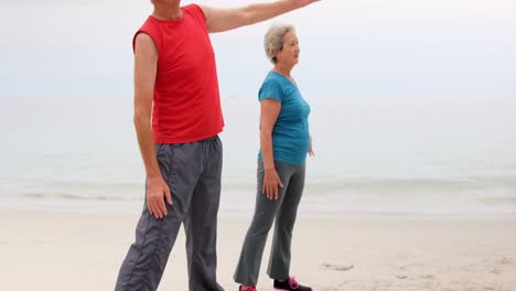 Retired-couple-doing-yoga-on-the-beach