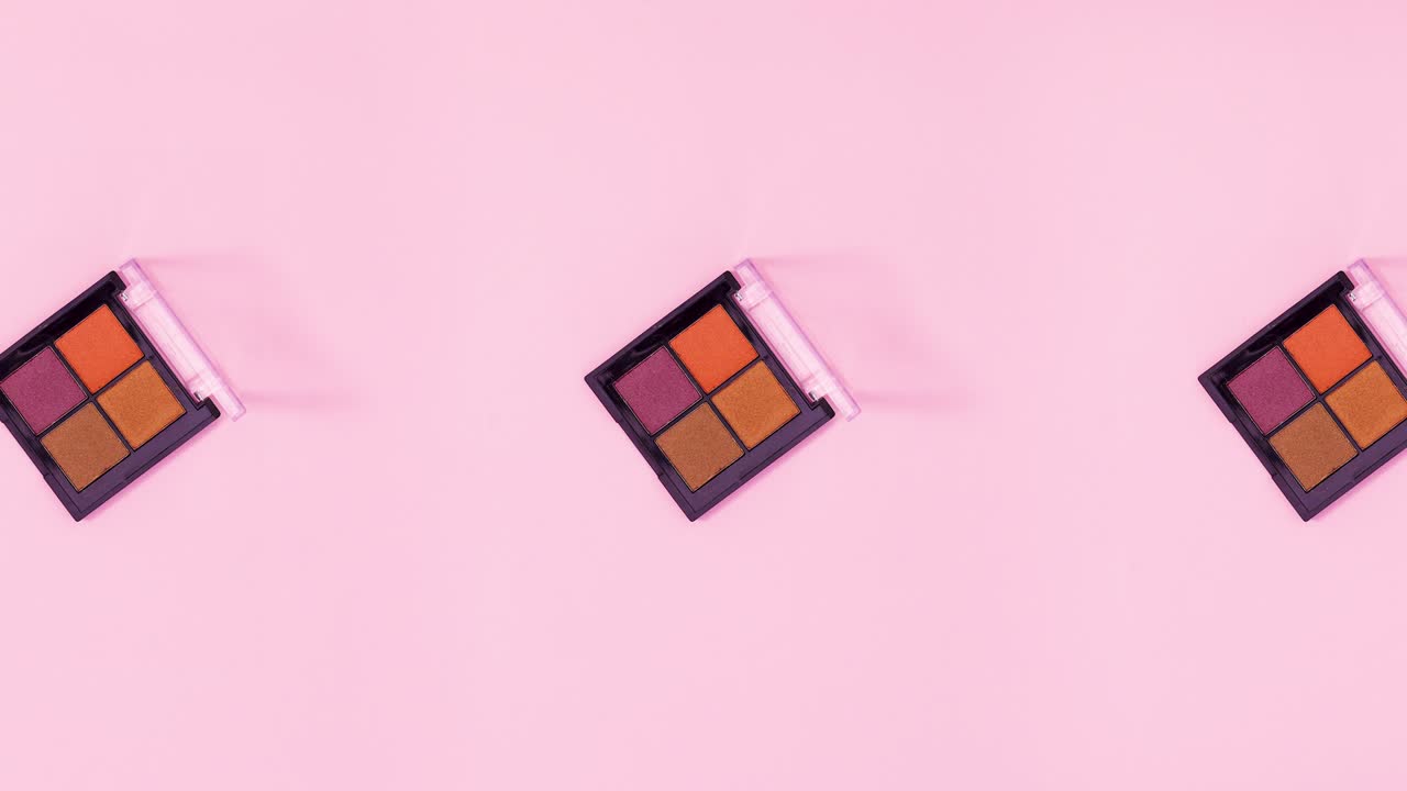 Group of Eye shadow palettes rotate and changing on bright pink theme. Stop motion