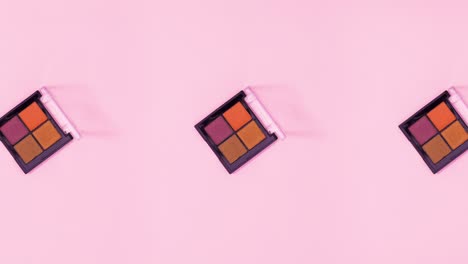 group of eye shadow palettes rotate and changing on bright pink theme. stop motion