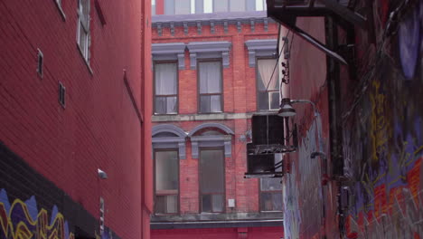 Panning-up-in-alleyway-from-snowy-ground-to-high-rise-condo