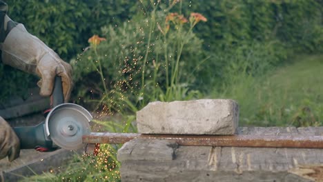 slow-motion-builder-cuts-part-of-metal-detail-on-old-table