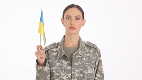 woman in military uniform holding a ukrainian flag