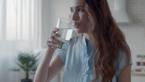 woman talking via headphones in white kitchen