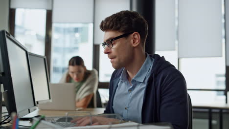 focused programmer checking code at desk. it guy professional solving problem