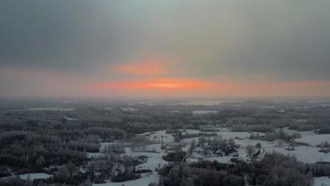 amazing nature phenomenon of a frozen forest in vibrant sunset. aerial view of winter landscape with snow covered and frozen trees in countryside. apocalyptic scenery after extreme cold in winter.
