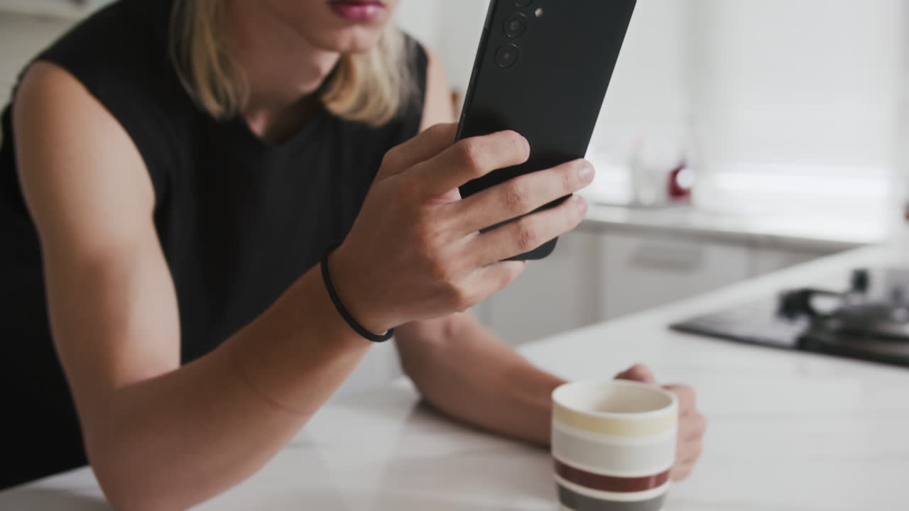 Gen Z Guy Messaging on Smartphone during Morning Coffee