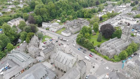 Aerial-view-of-Tavistock-town-center,-showcasing-historic-buildings,-roads,-and-green-spaces,-Devon,-UK