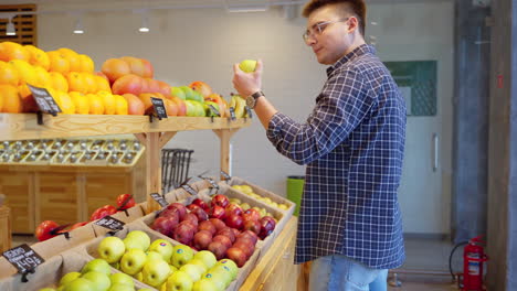 man shopping for fruit at a grocery store