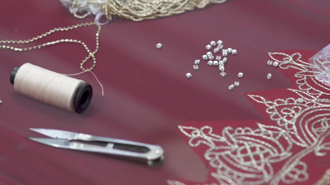 Closeup Of Textiles And Beads Used By A Tailor To Manufacture A Sari, Traditional Bridal Dress In Pakistan