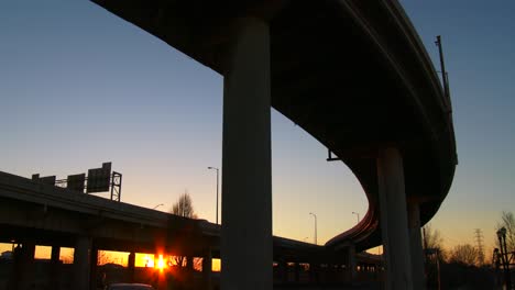 the arc of a freeway overpass at sunset