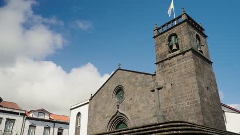 Slow-motion-close-up-shot-of-historic-church-bell-tower-in-Santa-Marta,-Sao-Miguel,-Azores---Portugal