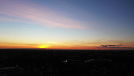 An-aerial-shot-over-a-suburban-neighborhood-during-a-golden-sunrise