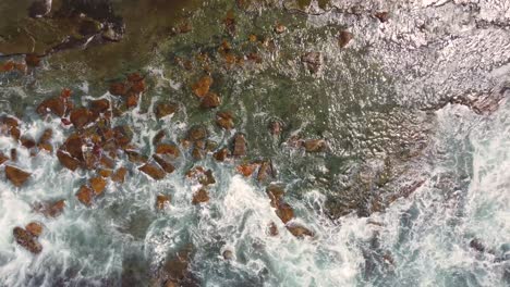 Drone-pan-from-rocky-reef-with-ocean-waves-over-Crackneck-Bateau-Bay-Central-Coast-NSW-Australia-3840x2160-4K