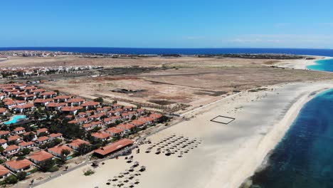 aerial over beach side villas next to empty plot of land in sal cape verde