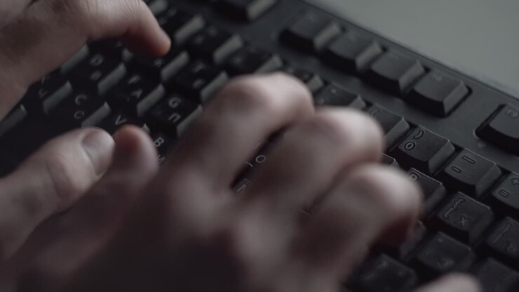Hands Typing on a Keyboard