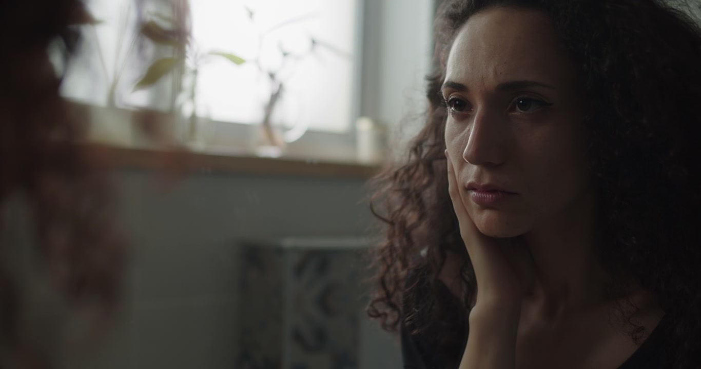 A very upset woman touching her hair