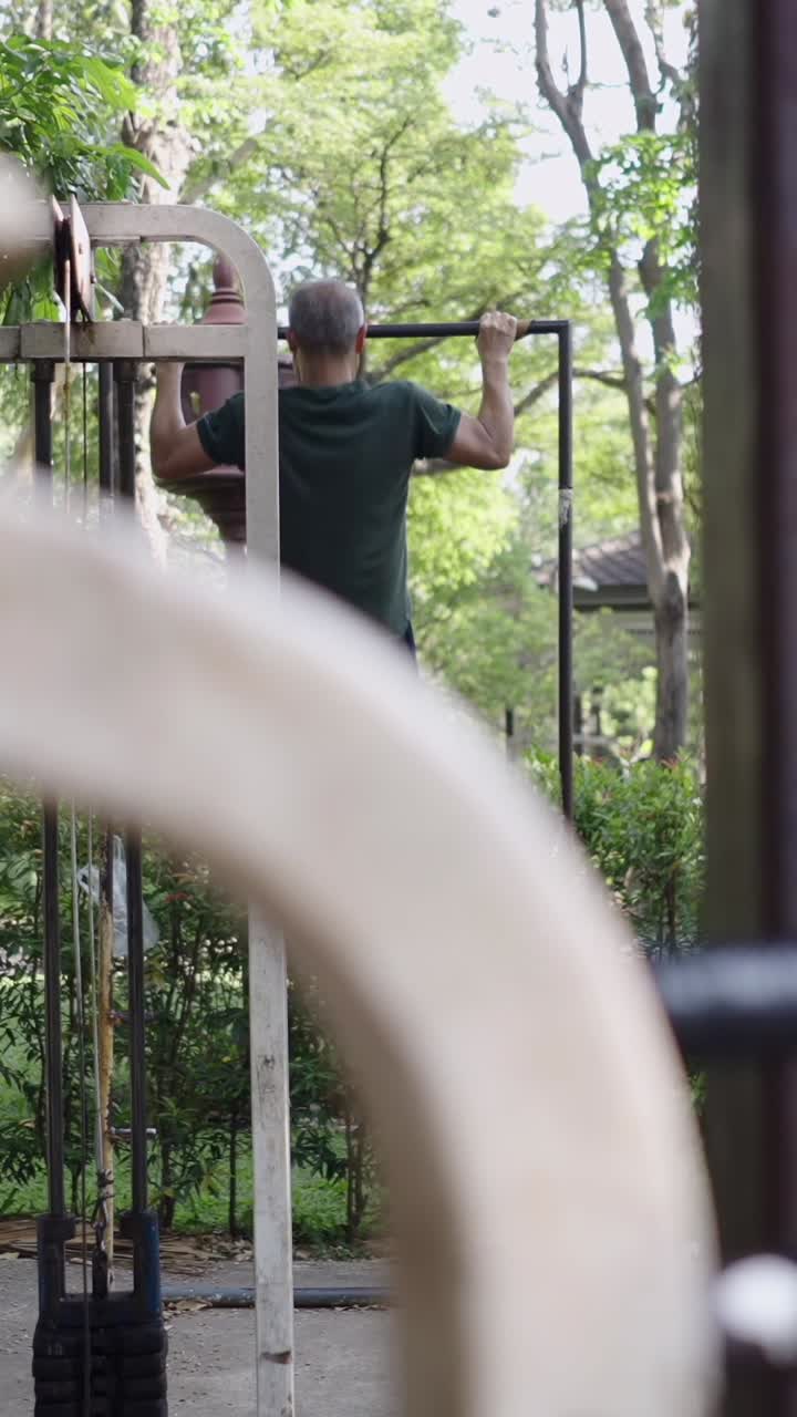 Man doing pull ups outdoors