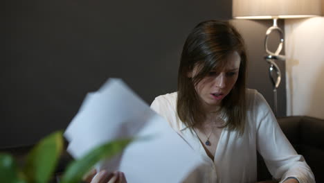 shocked woman at home looking at bills and debts during the cost of living crisis