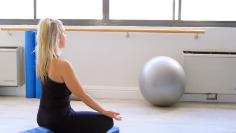 woman doing yoga in fitness gym 4k