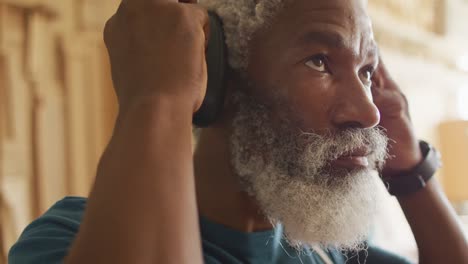 close up view of african american male carpenter wearing protective ear-muffs in a carpentry shop