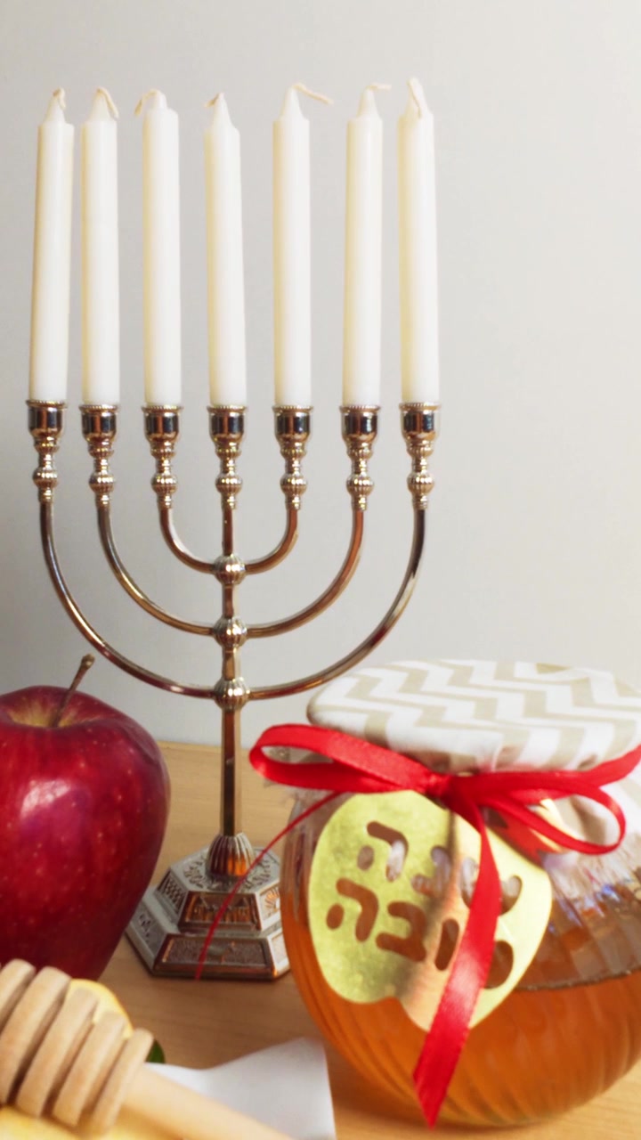 Traditional Rosh Hashanah Table Setting with Menorah, Honey, and Apples
