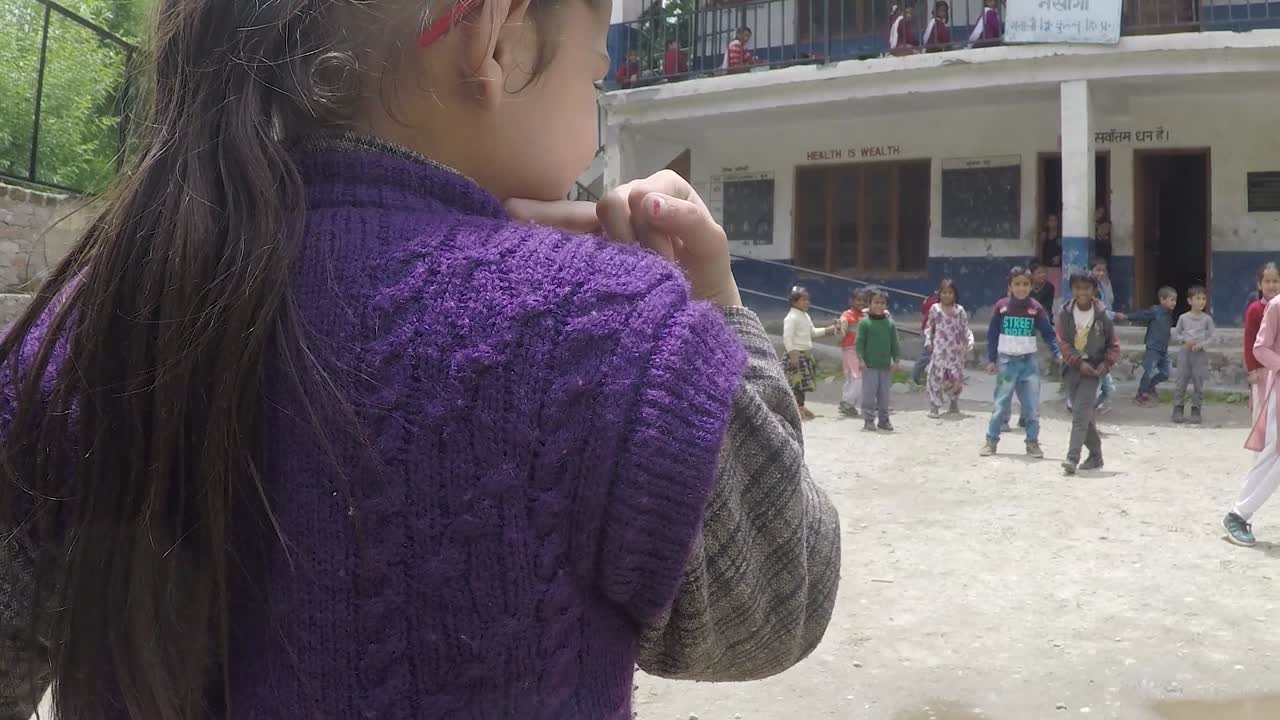 Manali, India, circa 2019 - Young children play tag at a village school in the Himalayas_1