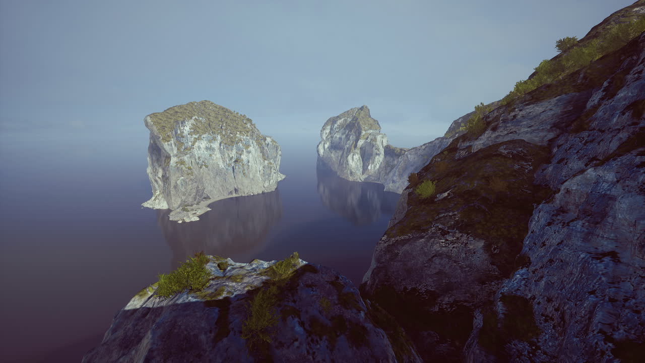 Scenic view of rocky islands reflecting in calm water during sunrise