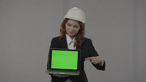 woman engineer presenting green screen laptop