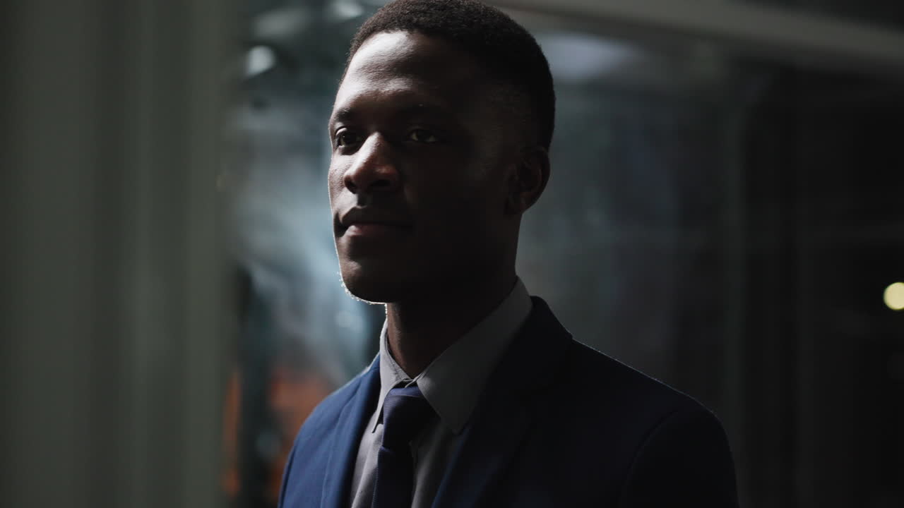 Thoughtful African American Businessman Looking Around in a Dark Office