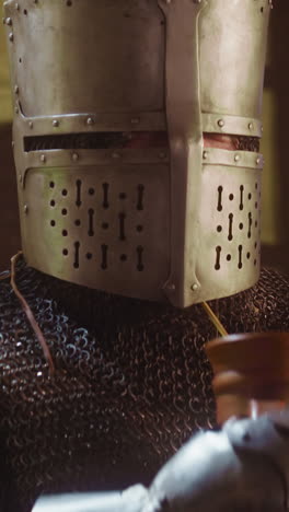 Knight drinks and straw stacks under visor in tavern. Strong medieval warrior enjoys alcohol beverage through dry hay stem in pub. Face armour problems