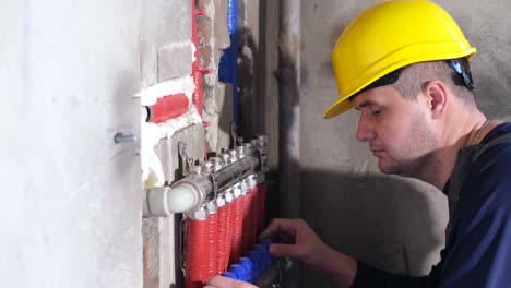 professional plumber connecting pipes installing kitchen sink faucet with expert precision skilled plumber performing precise pipe connections and faucet installation underneath kitchen sink demonstrating professional plumbing expertise and maintenance service
