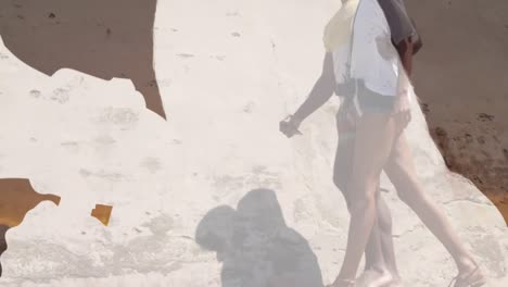 Animation-of-map-over-african-american-couple-on-the-beach